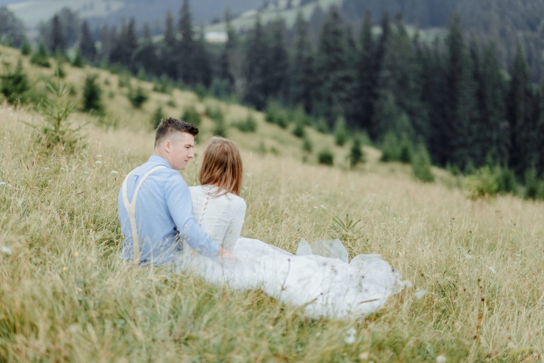 Romantic couple embracing during anniversary photoshoot with natural scenic backdrop in Hyderabad